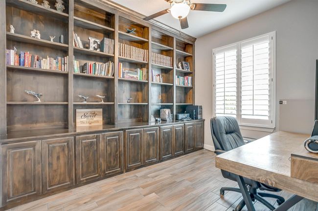 Office area with ceiling fan and light wood-style flooring | Image 33