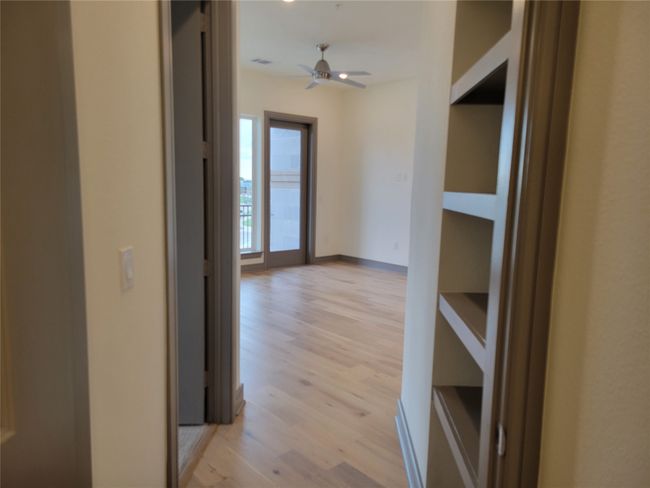 Hall with light wood-style flooring and baseboards | Image 13