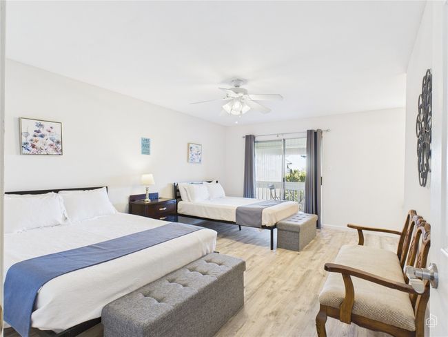 Downstairs bedroom featuring access to private exterior deck and backyard area. This room has an ensuite bathroom. | Image 18