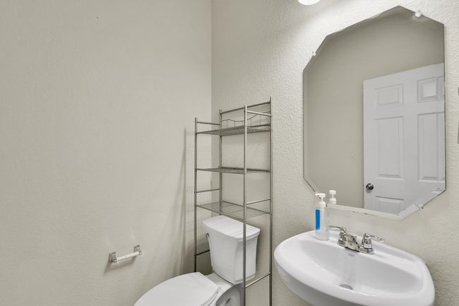 Bathroom with toilet and a sink | Image 12