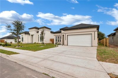 View of front of house featuring a front yard and a garage | Image 3