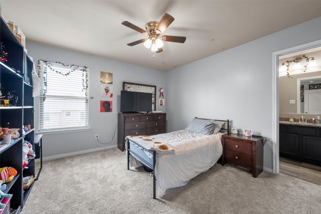 Bedroom featuring carpet floors, ensuite bath, and a ceiling fan | Image 25