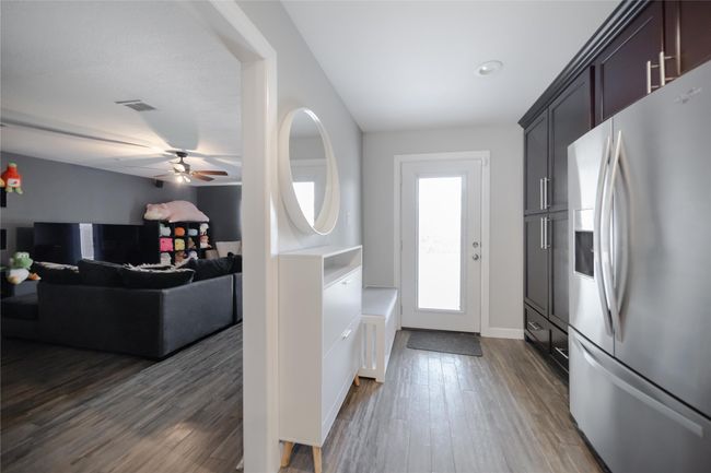 Foyer with dark wood finished floors and a ceiling fan | Image 17