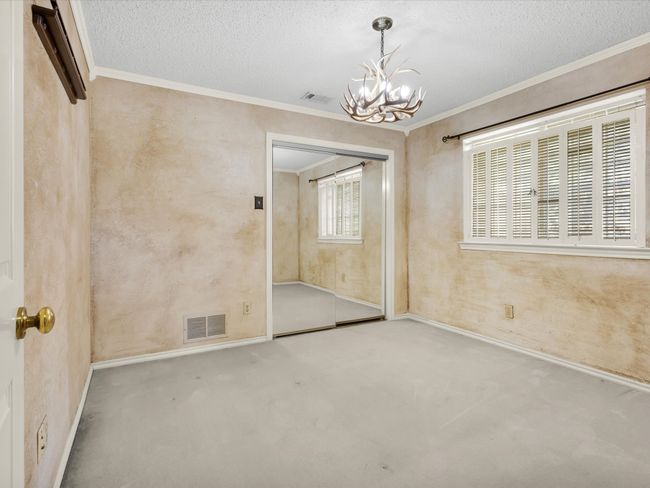 Third bedroom has a row of decorative windows and sliding mirrored doors to the closet. | Image 33