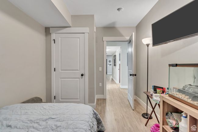 Bedroom with light wood-style flooring and baseboards | Image 13