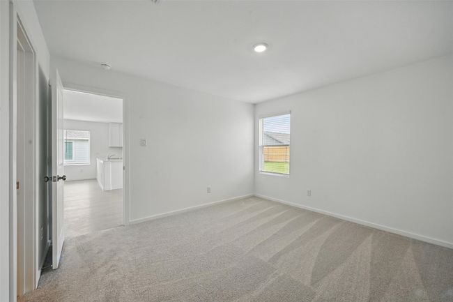 Spare room featuring light carpet and healthy amount of natural light | Image 12