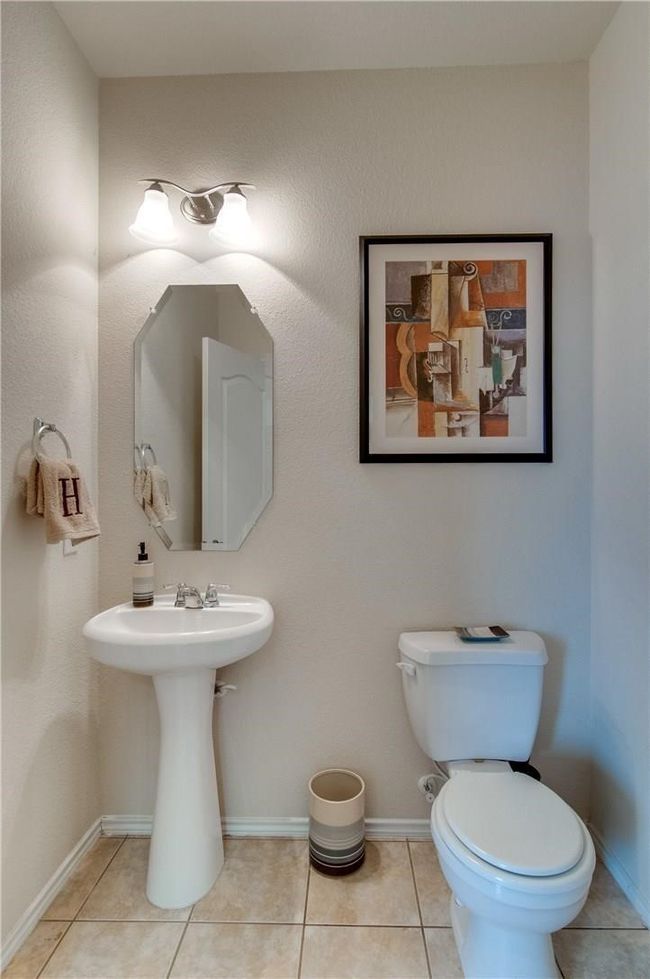 Bathroom with sink, tile patterned floors, and toilet | Image 14
