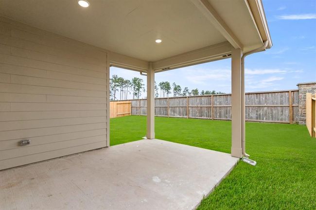 Imagine stepping into your own personal oasis—a spacious covered back patio that invites you to savor every moment outdoors, regardless of the weather. | Image 22