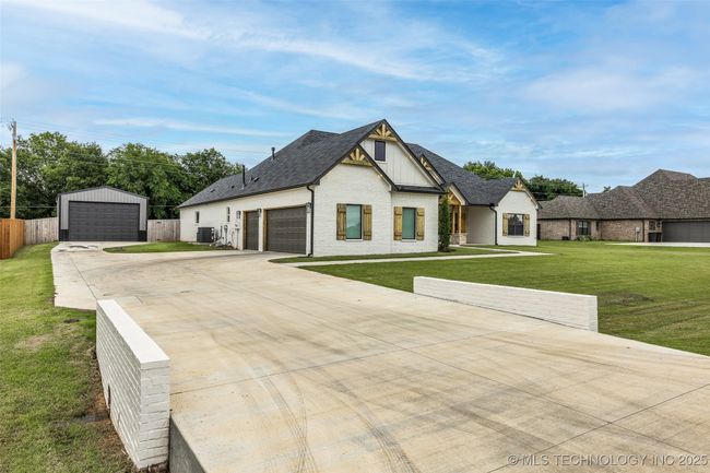 Extended driveway to side entry garage and large workshop | Image 4