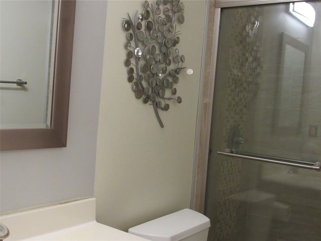 Bathroom featuring a shower stall and toilet | Image 16