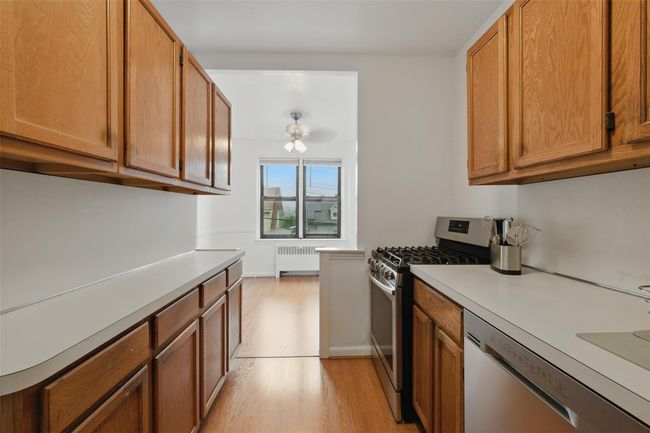 Kitchen flows into dining room. | Image 7