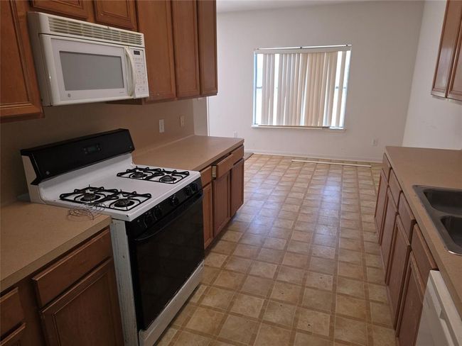 Kitchen offers gas cooking and lots of counter space | Image 4