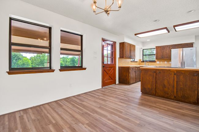 Dining area shows the windows to the covered back patio. | Image 12