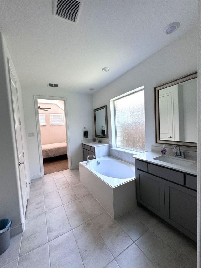 Bathroom featuring vanity, a garden tub, tile patterned flooring, and ensuite bathroom | Image 8