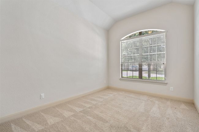 Spare room with vaulted ceiling and carpet | Image 9