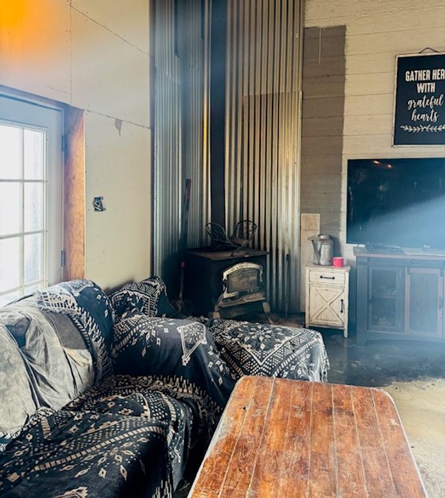 Bedroom with a wood stove and wooden walls | Image 10