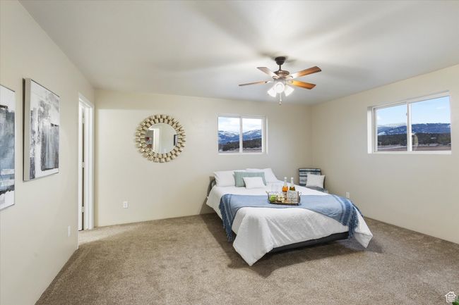 Bedroom featuring a ceiling fan and carpet floors | Image 12