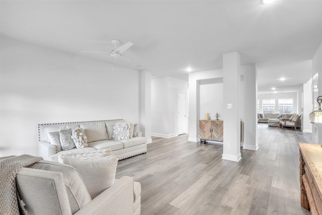 Living room featuring ceiling fan and light wood-type flooring | Image 6