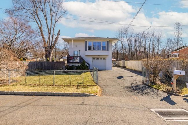 View of front of house with oversized driveway, garage, fence and front lawn | Image 36