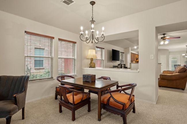 Another perspective of the entry space showing additional seating, classic built-ins, and a clear path to main living areas. | Image 8