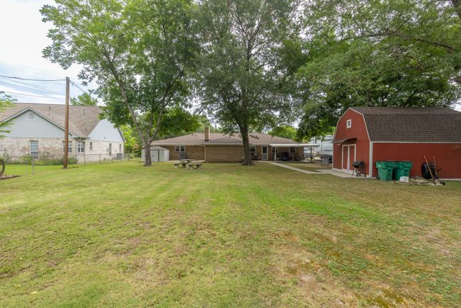 View of yard featuring a barn and a shed | Image 38