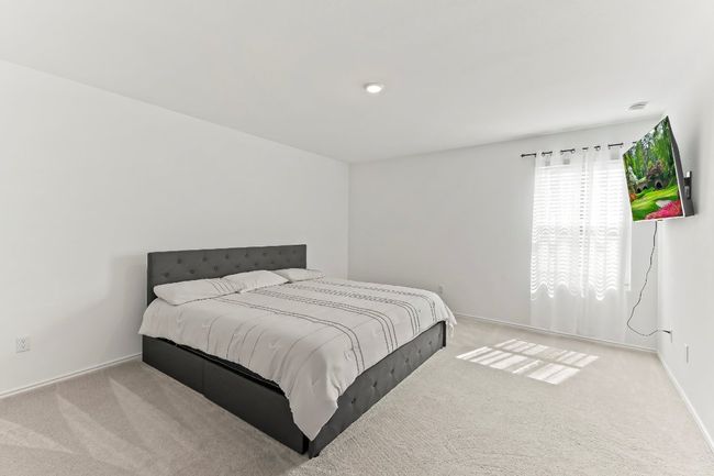 Carpeted bedroom with baseboards | Image 22