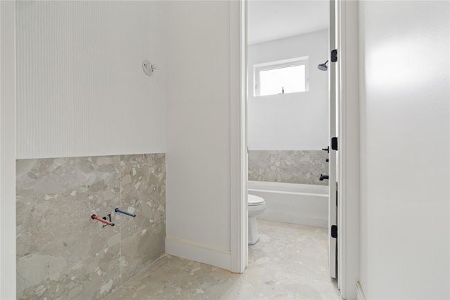 Full bath with baseboards, a bathtub, and toilet | Image 27