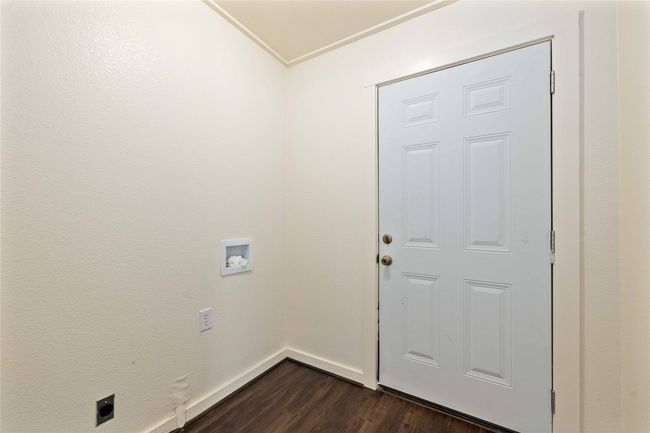 Laundry room with electric dryer hookup, dark wood-style flooring, and washer hookup | Image 22