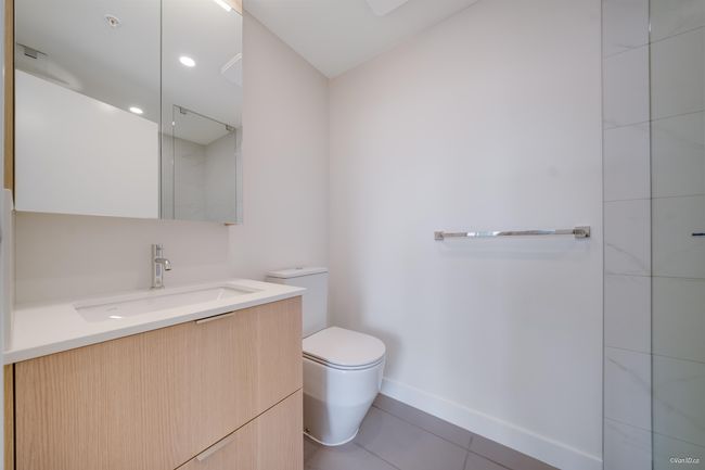 Full bath with toilet, vanity, tile patterned floors, and baseboards | Image 8