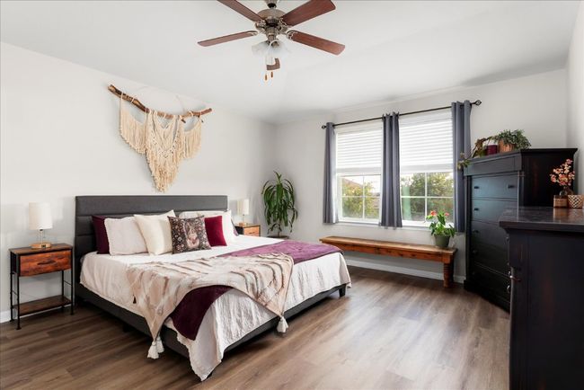 Bedroom featuring wood finished floors, a ceiling fan, and baseboards | Image 12