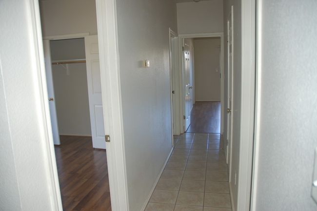 Hallway with baseboards and light tile patterned flooring | Image 9