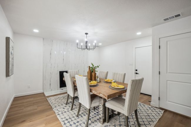 Dining space with a chandelier, wood finished floors, recessed lighting, and baseboards | Image 7