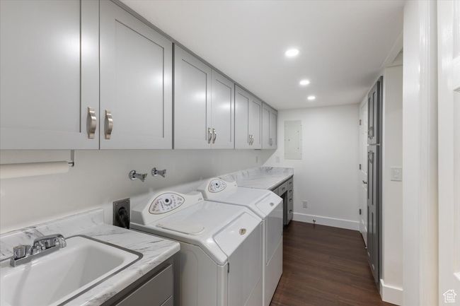 Laundry room featuring recessed lighting, dark wood-style floors, independent washer and dryer, cabinet space, and a sink | Image 29
