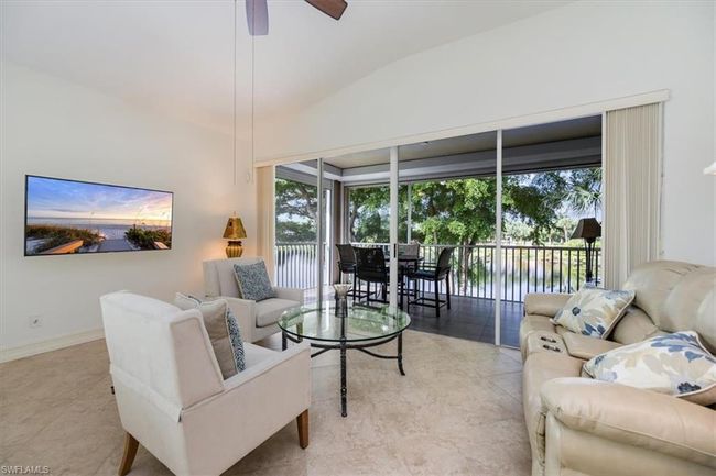 Living room featuring vaulted ceiling and ceiling fan | Image 4