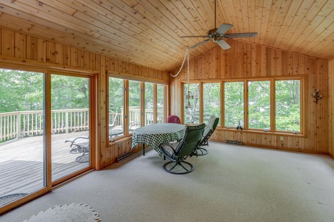 Four season porch leads out to the lake side deck ~ you will love relaxing here! | Image 19