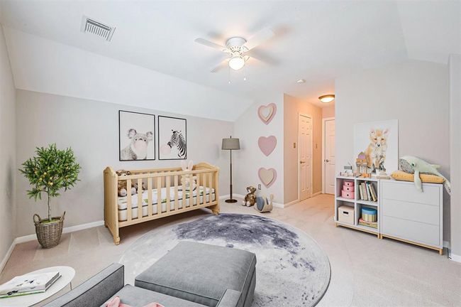Fourth bedroom upstairs, with walk in closet and vaulted ceiling. Virtual staging. | Image 31