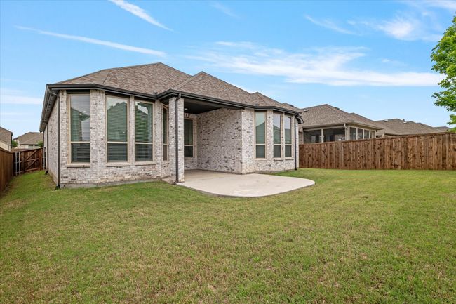 Back of property with a fenced backyard, a lawn, a patio area, and brick siding | Image 17