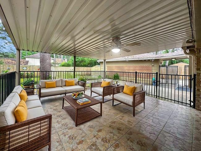 Outside, enjoy a covered patio with a lighted fan and an enclosure.VIRTUALLY STAGED | Image 17