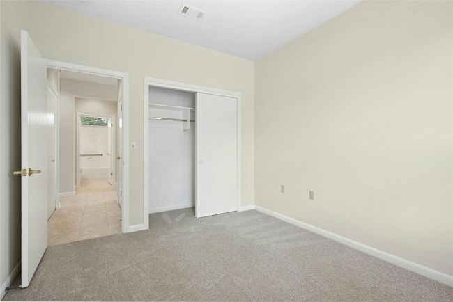 Unfurnished bedroom with carpet floors, baseboards, and a closet | Image 14