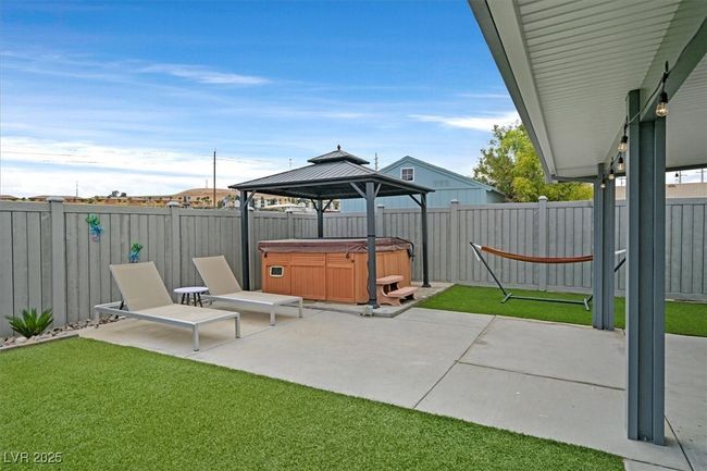 View of patio / terrace featuring a gazebo, a fenced backyard, and a hot tub | Image 31