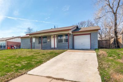 Ranch-style house with a garage and a front lawn | Image 2