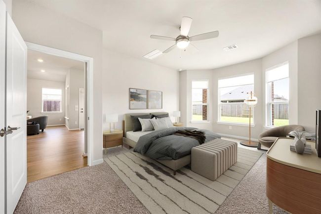 Virtually staged Primary Bedroom with large bay window for sitting with a good book with lighted ceiling fan. | Image 16