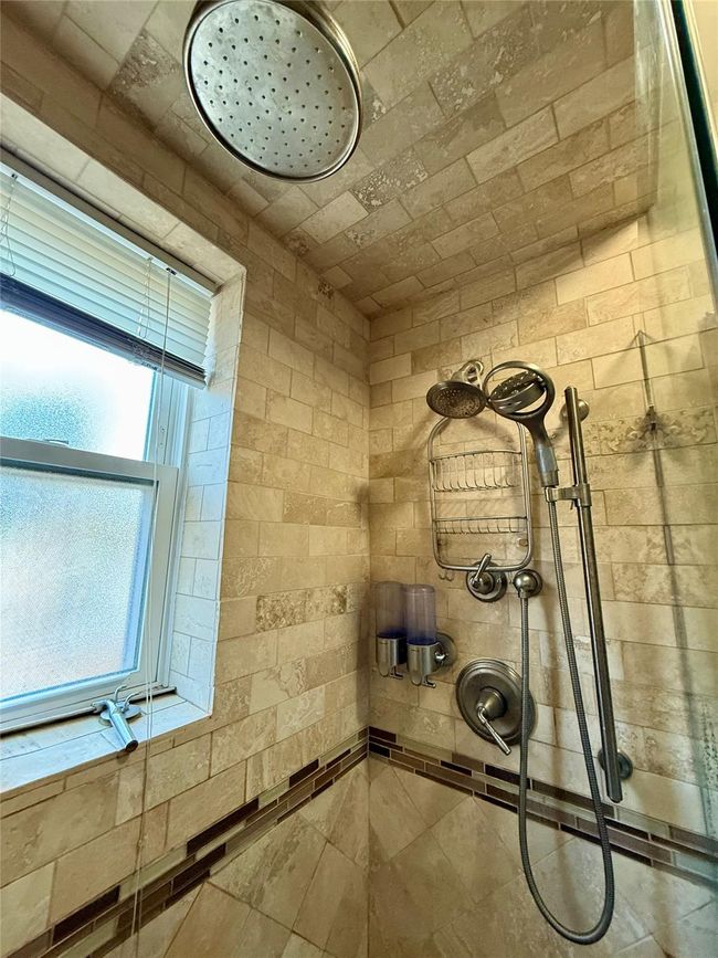 Interior details featuring a tile shower | Image 13