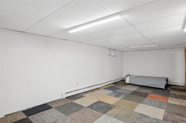 Finished basement with a baseboard radiator and a drop ceiling | Image 23
