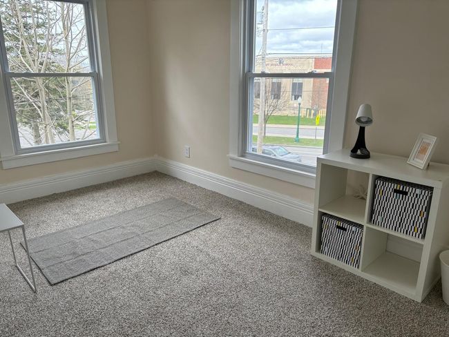 Unfurnished dining area with healthy amount of natural light, carpet, and baseboards | Image 8