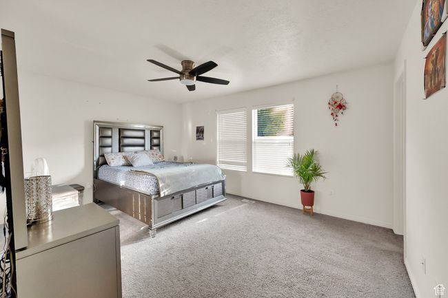 Carpeted bedroom with ceiling fan | Image 13