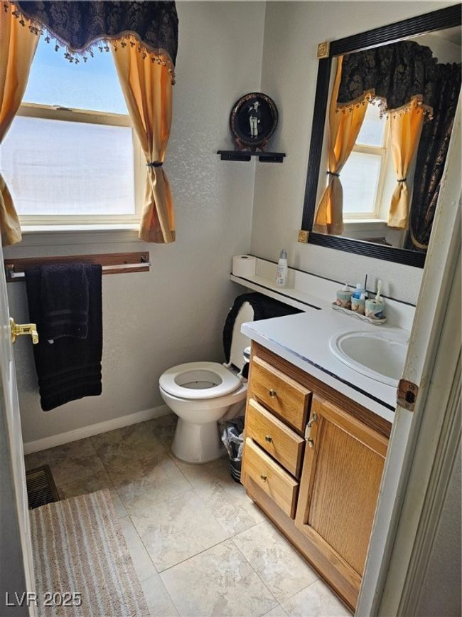 Half bath featuring toilet, vanity, baseboards, and visible vents | Image 21