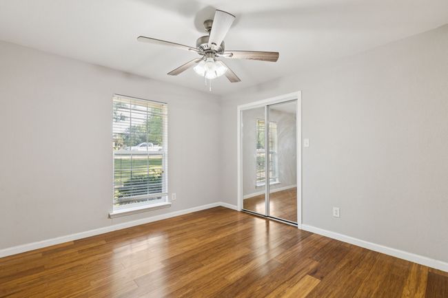 Empty room with wood finished floors and a ceiling fan | Image 13
