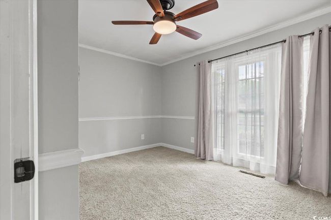 Carpeted spare room with a ceiling fan, ornamental molding, and baseboards | Image 20