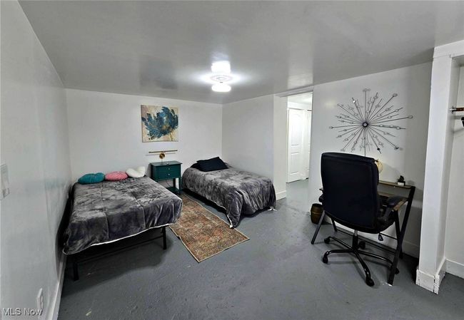 Bedroom featuring baseboards and concrete flooring | Image 46